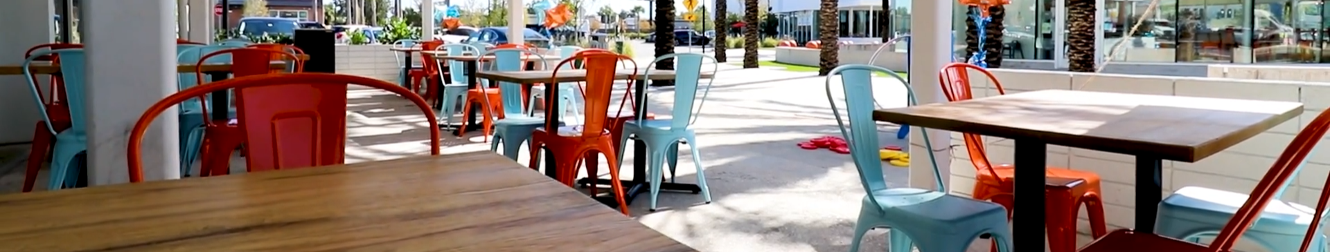 Blue Coast Burrito patio with colorful coastal seating
